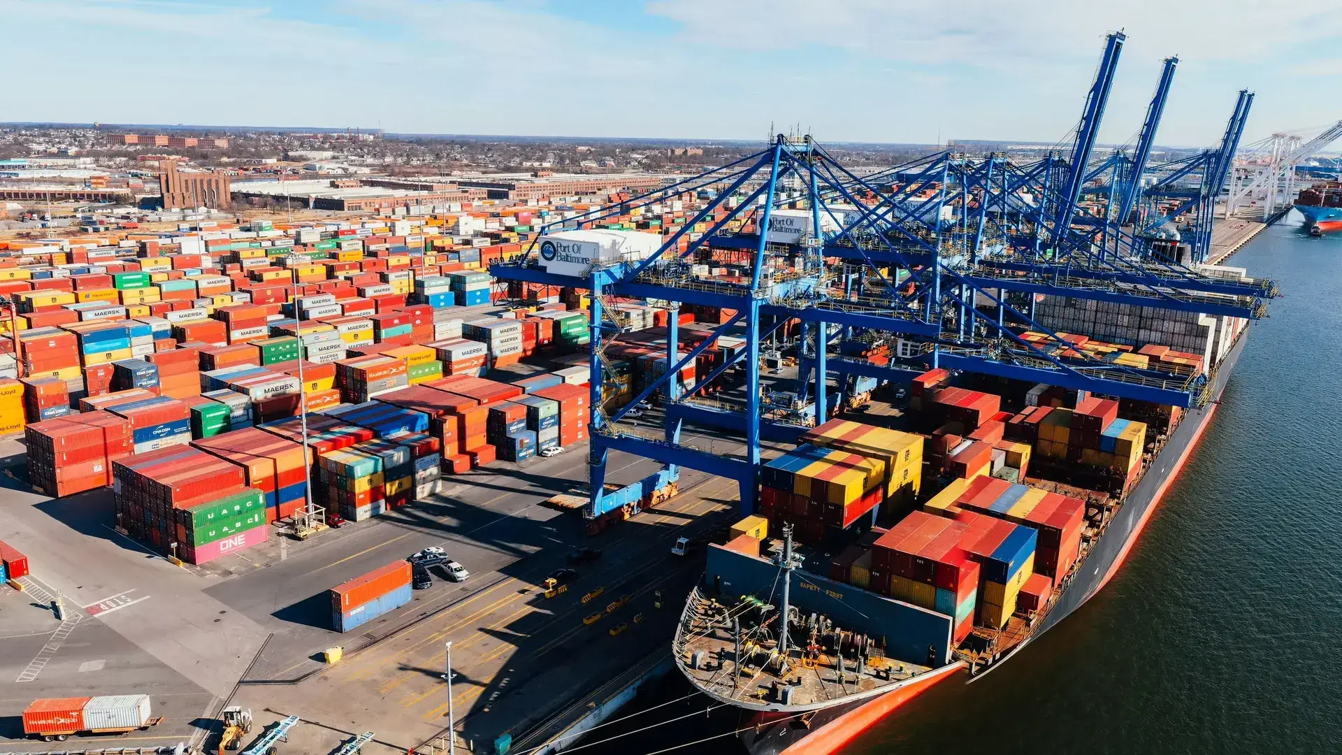Container terminal with gantry cranes loading a cargo ship